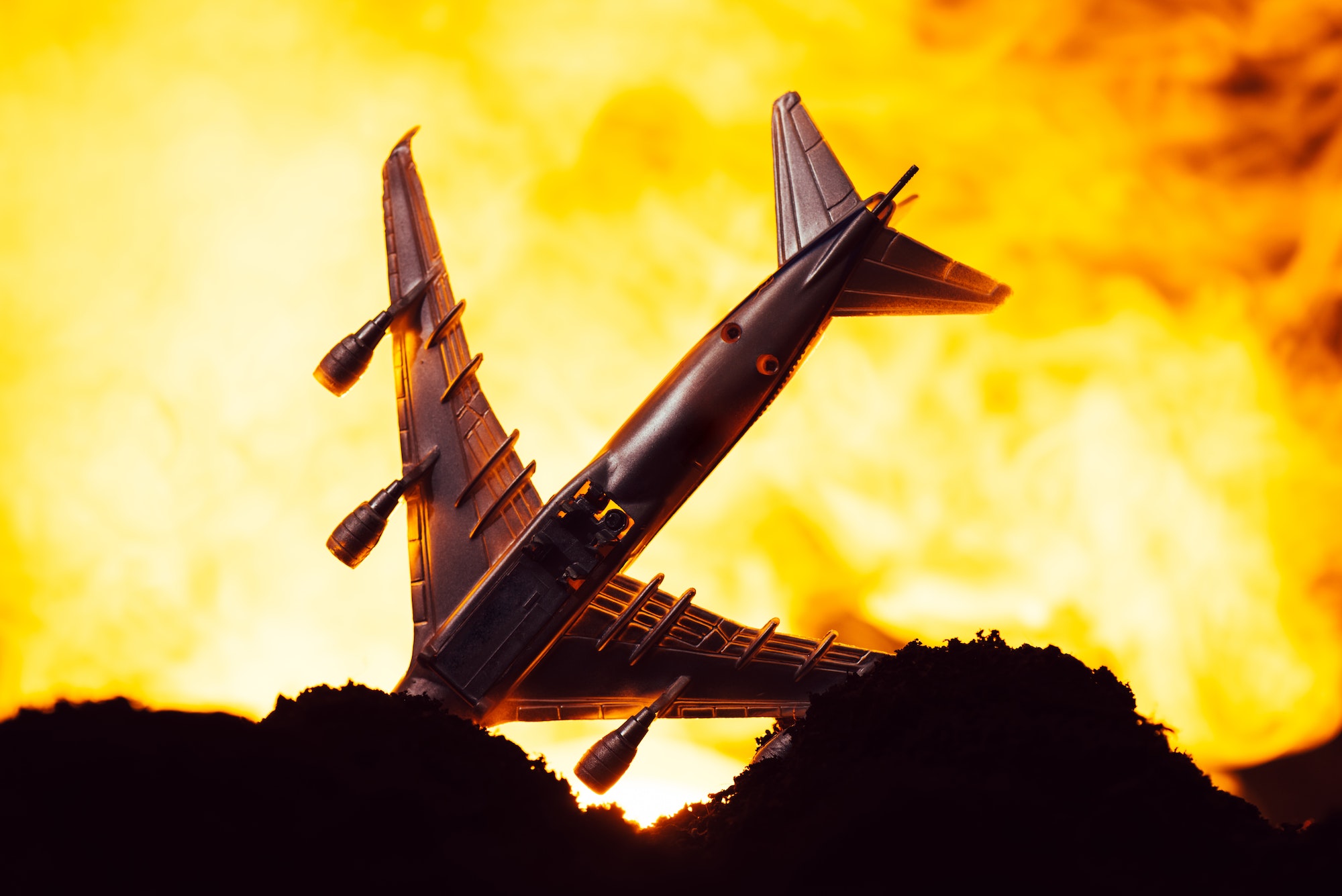 Battle scene with crash of toy plane with fire at background